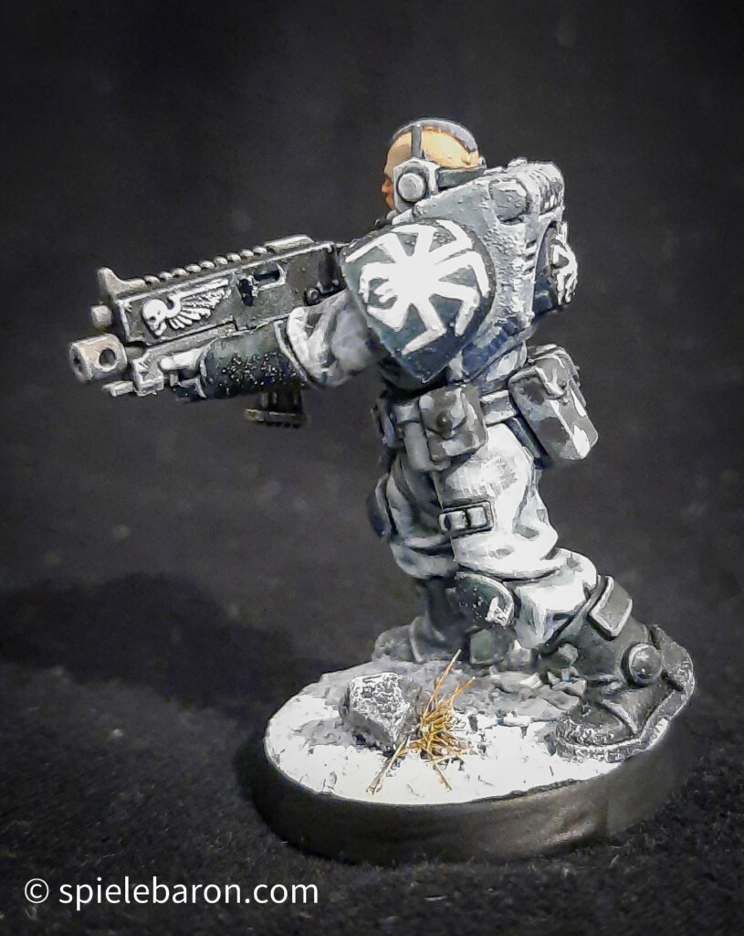 Foto eines Space Marine Primaris Scouts mit Boltgewehr in Winter-Camouflage, bemalt mit Winterbase vor schwarzem Hintergrund; seitlich